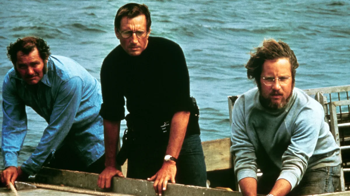 External conflict in film: Quint, Brody and Hooper lean over the side of the Orca in Jaws (1975)
