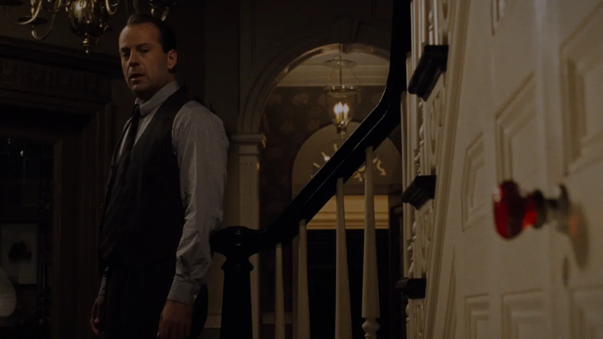 Foreshadowing examples in movies: Malcolm Crowe beside the red doorknob of the basement door in The Sixth Sense